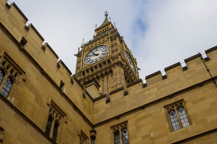 Photograph of Big Ben, a below photo showing just the clock face angled against a cloudy sky.