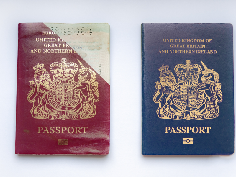 Two UK passports back to back, one is the old style EU red passport, the other is the newer blue passport.